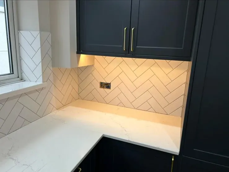 Mustard herringbone splashback by Prestige Tiling